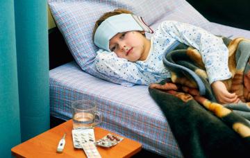 Pronóstico de la varicela Niño con varicela en cama