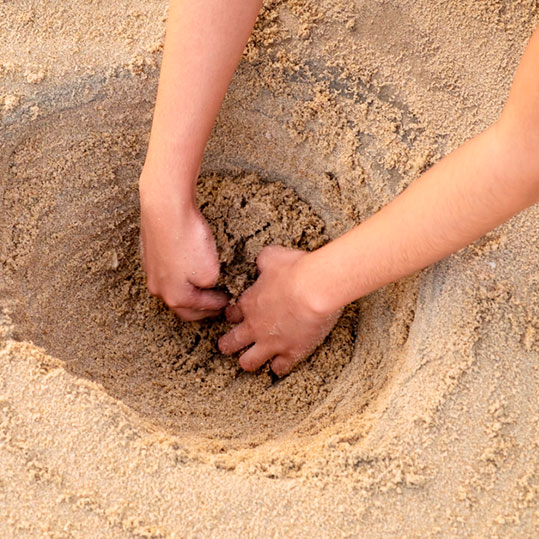 Hacer agujeros en la arena de la playa