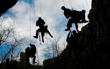 Prevención de accidentes en la montaña Un grupo de alpinistas realizan una escalada