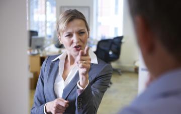 Empresaria en actitud rigida e inflexible con un empleado