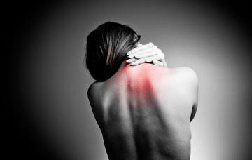 Mujer con dolores en la espalda debido a la fibromialgia