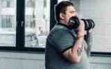 Hombre con obesidad realizando ejercicio con pesas para reducir la grasa del corazón
