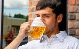 Hombre joven bebiendo una jarra de cerveza
