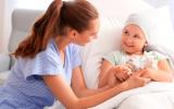 Enfermera hablando con una niña enferma de cáncer