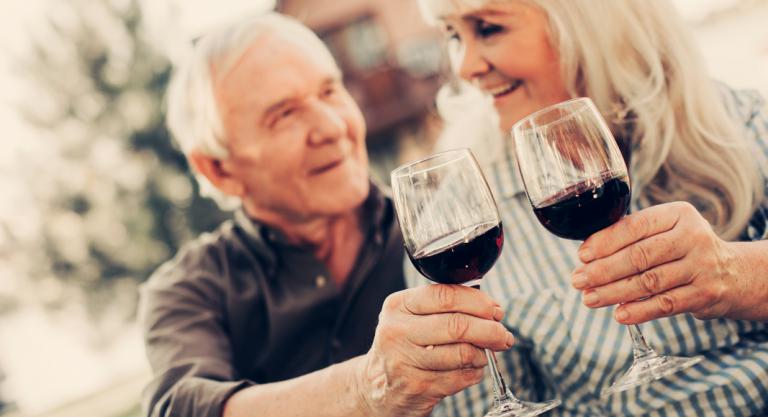 Personas mayores bebiendo vino