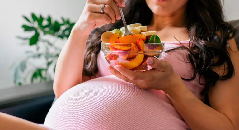 Pregnant woman guaranteeing iodine intake