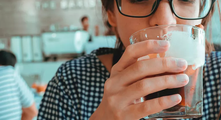 Woman having a glass of cold brew coffee