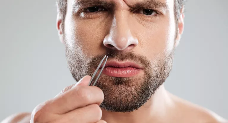 Removing nose hairs with tweezers