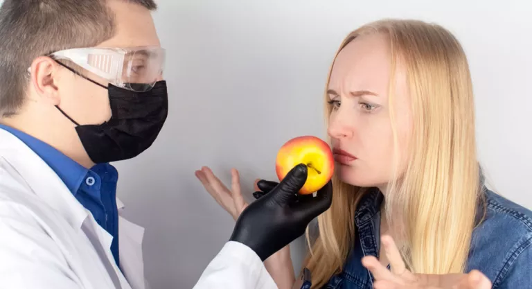 Therapist making a girl smell a fruit