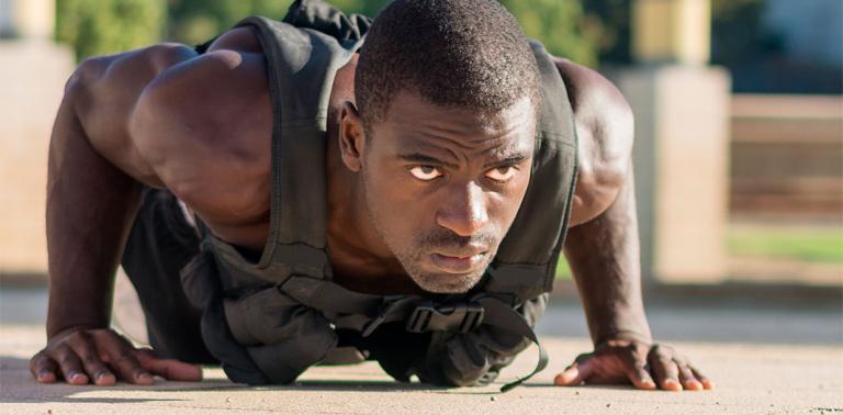 Man doing push ups with a weight vest