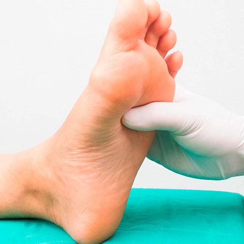 Un profesional sanitario examina el pie de un paciente