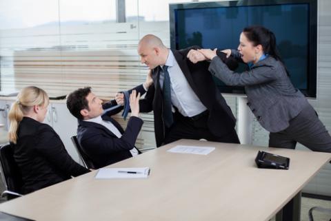 Persona agrediendo a otra en una reunión de negocios