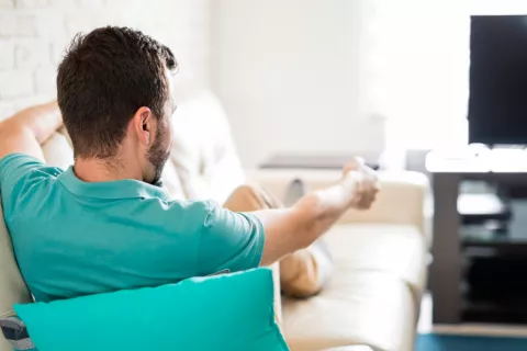 Hombre viendo la televisión aumentando así el riesgo cardiovascular