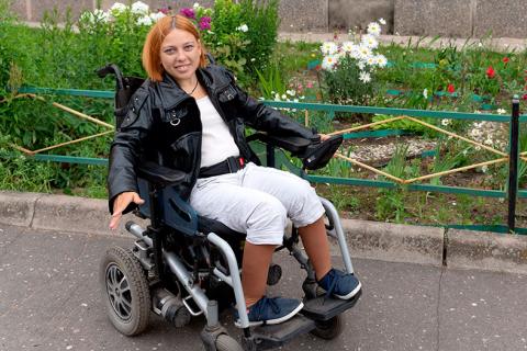 Mujer joven sentada en uns silla de ruedas