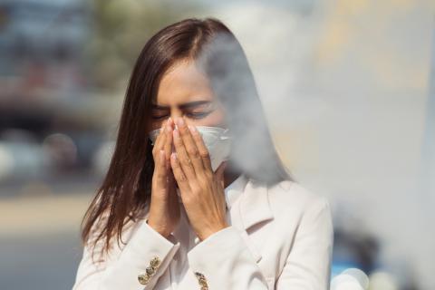 Mujer con mascarilla debido a la contaminación del aire