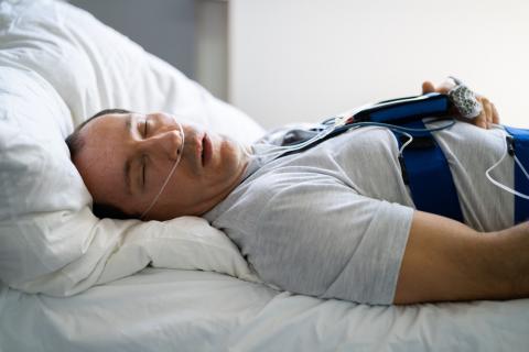 Un hombre durmiendo en el hospital durante el tratamiento de la apnea del sueño