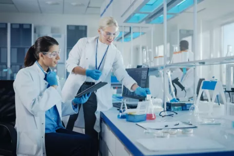 Mujeres científicas trabajan en un laboratorio probando fármacos Dos científicas analizan muestras bioquímicas en un laboratorio