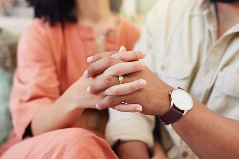 Dos personas cogidas de la mano en símbolo de lealtad