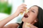 Mujer con food craving devorando patatas