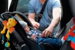 Cómo colocar la sillita del coche del bebé Padre coloca la sillita del coche de su bebé