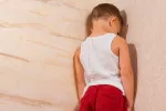 El abuso emocional en la niñez predispone a la migraña Niño castigado de cara a la pared