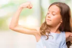 Asocian tener más músculo en la infancia con mejor salud respiratoria Niña mostrando sus músculos