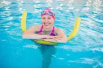 Señora en la piscina haciendo ejercicios acuáticos