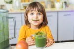 Dieta vegana en niños buena para su corazón Niño tomándose un smoothie vegano