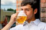 Hombre joven bebiendo una jarra de cerveza