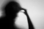 La memoria del miedo es diferente en hombres y mujeres Reflejo borroso de un hombre con miedo sujetándose la frente