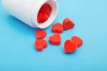 Un medicamento para tratar afecciones cardíacas retrasa la progresión del párkinson Frasco volcado del que salen píldoras en forma de corazón