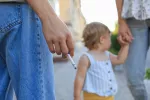 La exposición al humo del tabaco en la infancia altera peligrosamente el ADN Padres fumadores paseando junto a su hija pequeña