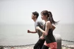 Caminata japonesa a intervalos Joven pareja asiática corriendo al aire libre junto al mar