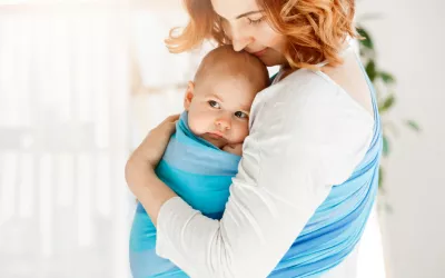 Claves para un porteo seguro Mujer con su bebé con un sistema de porteo seguro